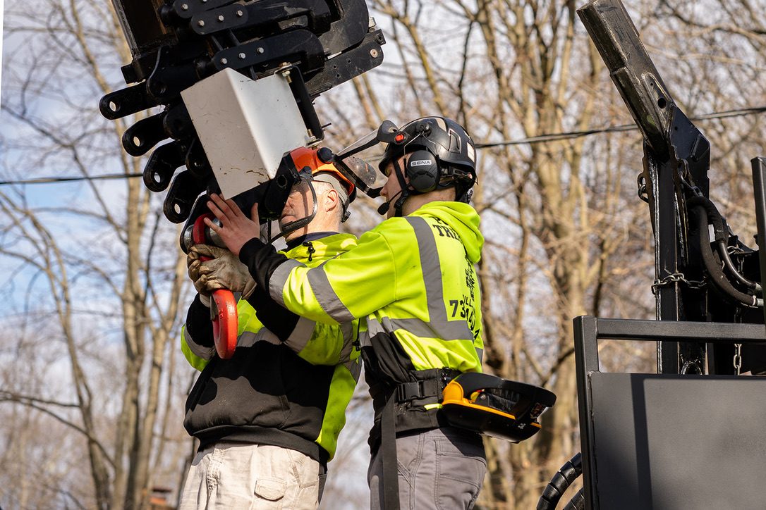 Pro-Stump crew operating a crane on a removal