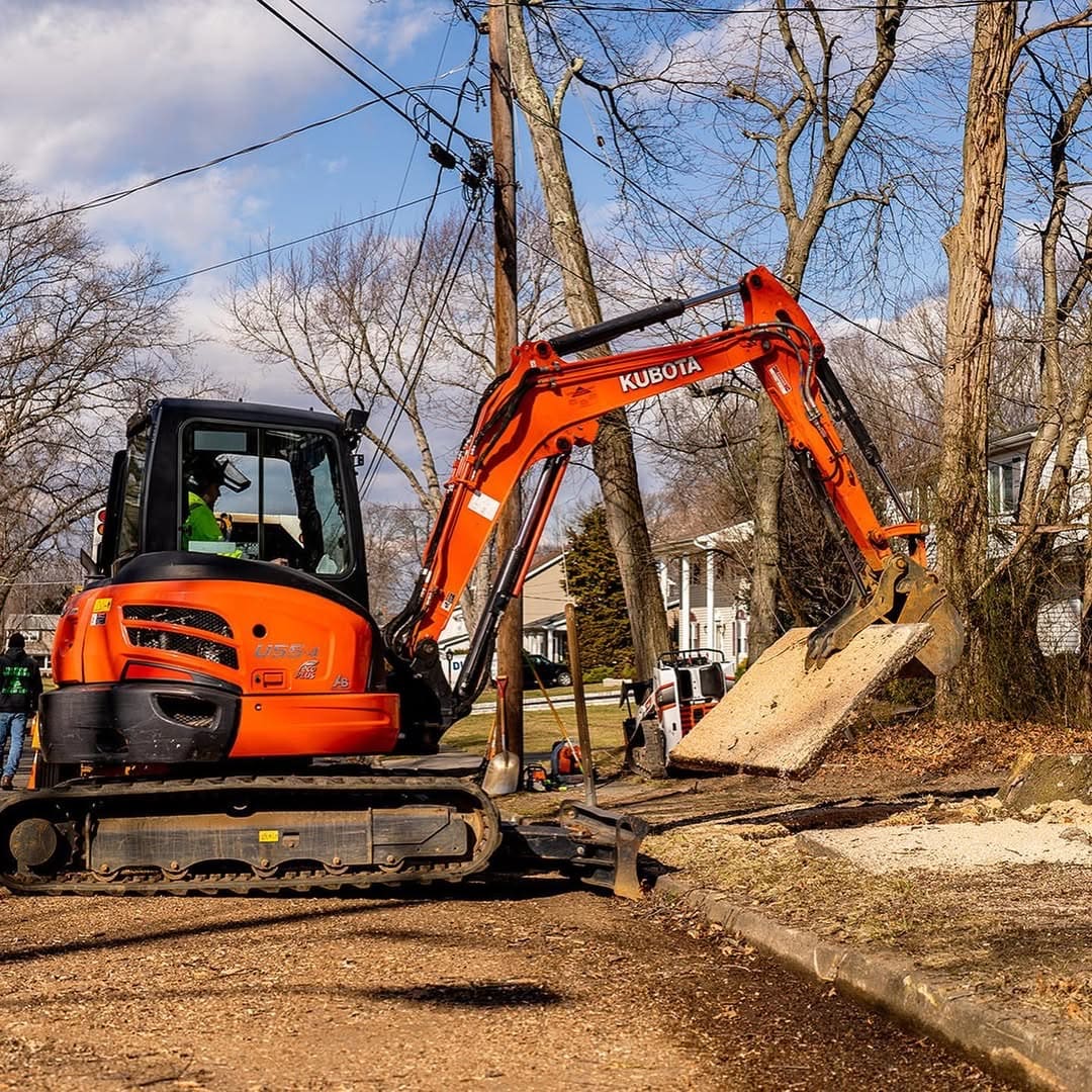 Pro-Stump Tree Service excavator at work clearing debris
